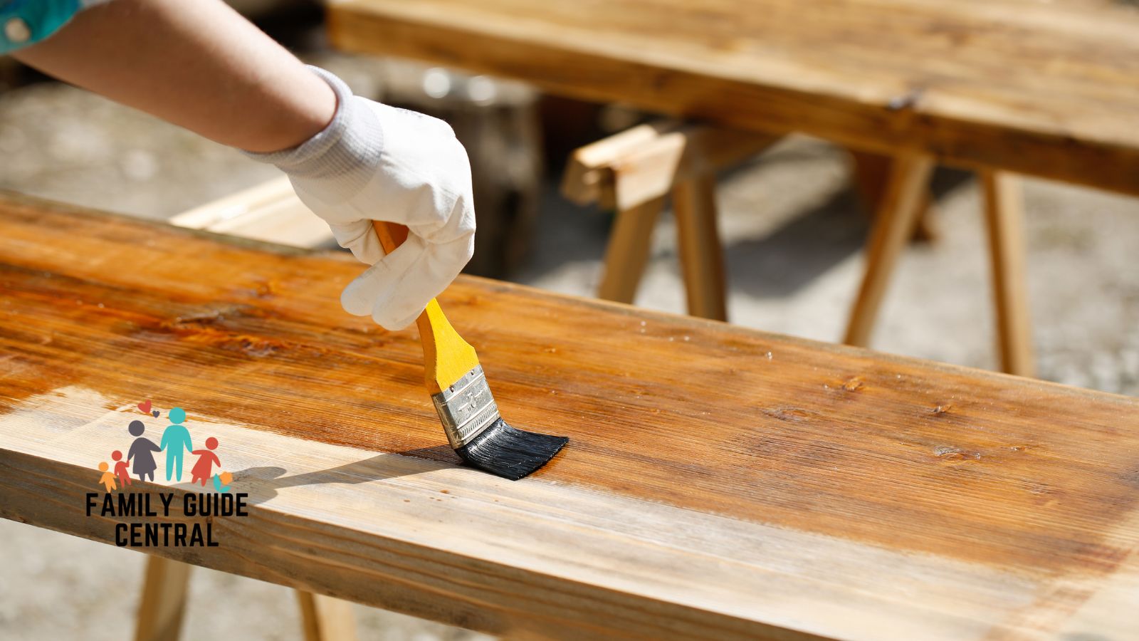 Man brushing finishing on wooden table - familyguidecentral.com