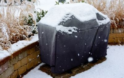 Gas grill covered from the snow