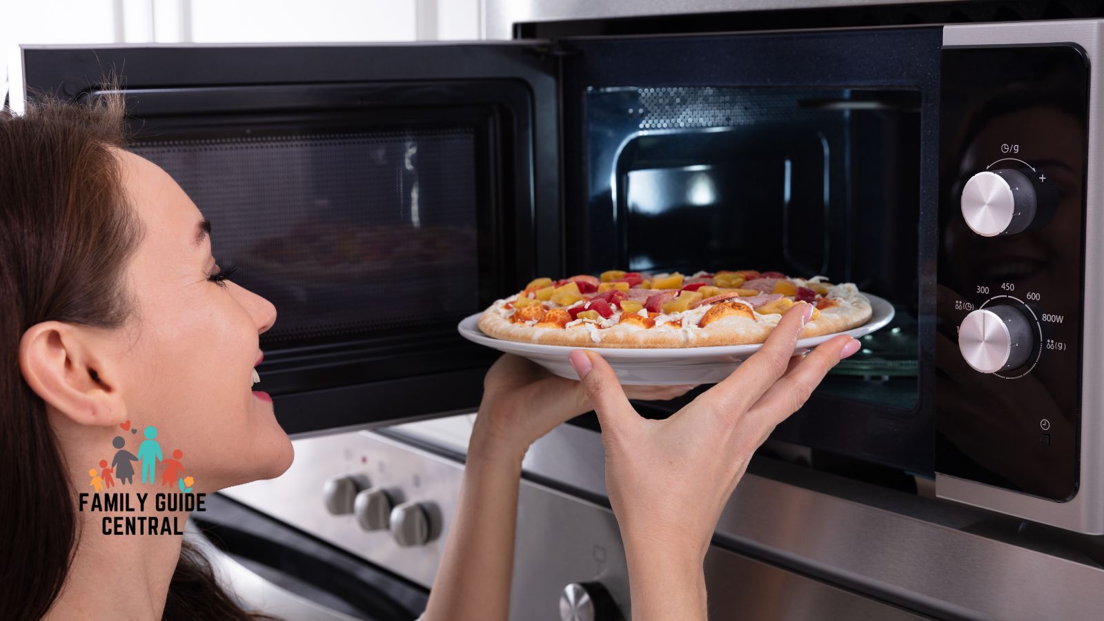 Lady microwaving a pizza - familyguidecentral.com
