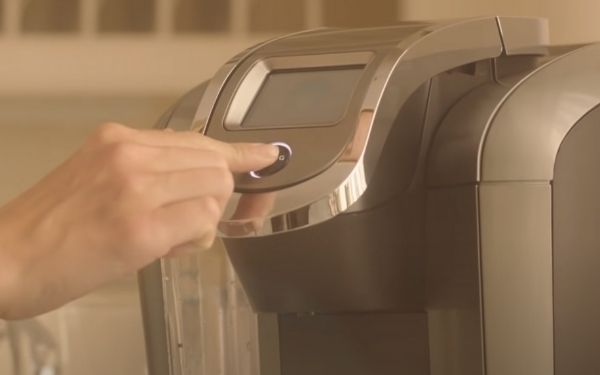 11. Press and hold the keurig button - FamilyGuideCentral.com