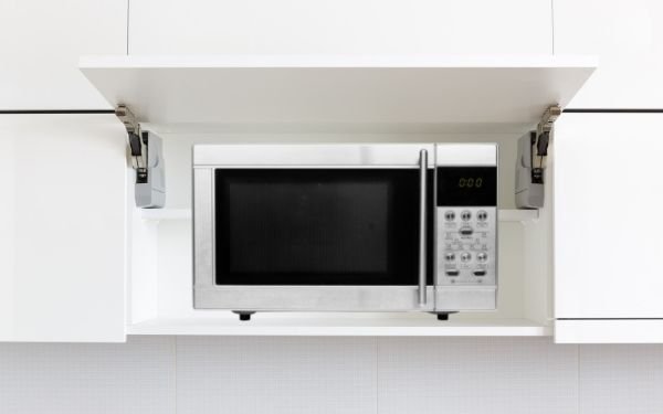 Microwave enclosed in cabinet - FamilyGuideCentral.com