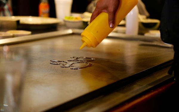 Spraying oil on top of a griddle - familyguidecentral.com